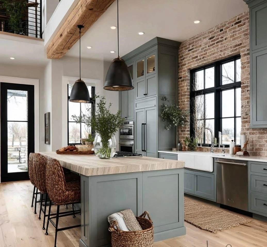 Modern farmhouse kitchen with grey cabinets, wooden island, and a large exposed brick accent wall.