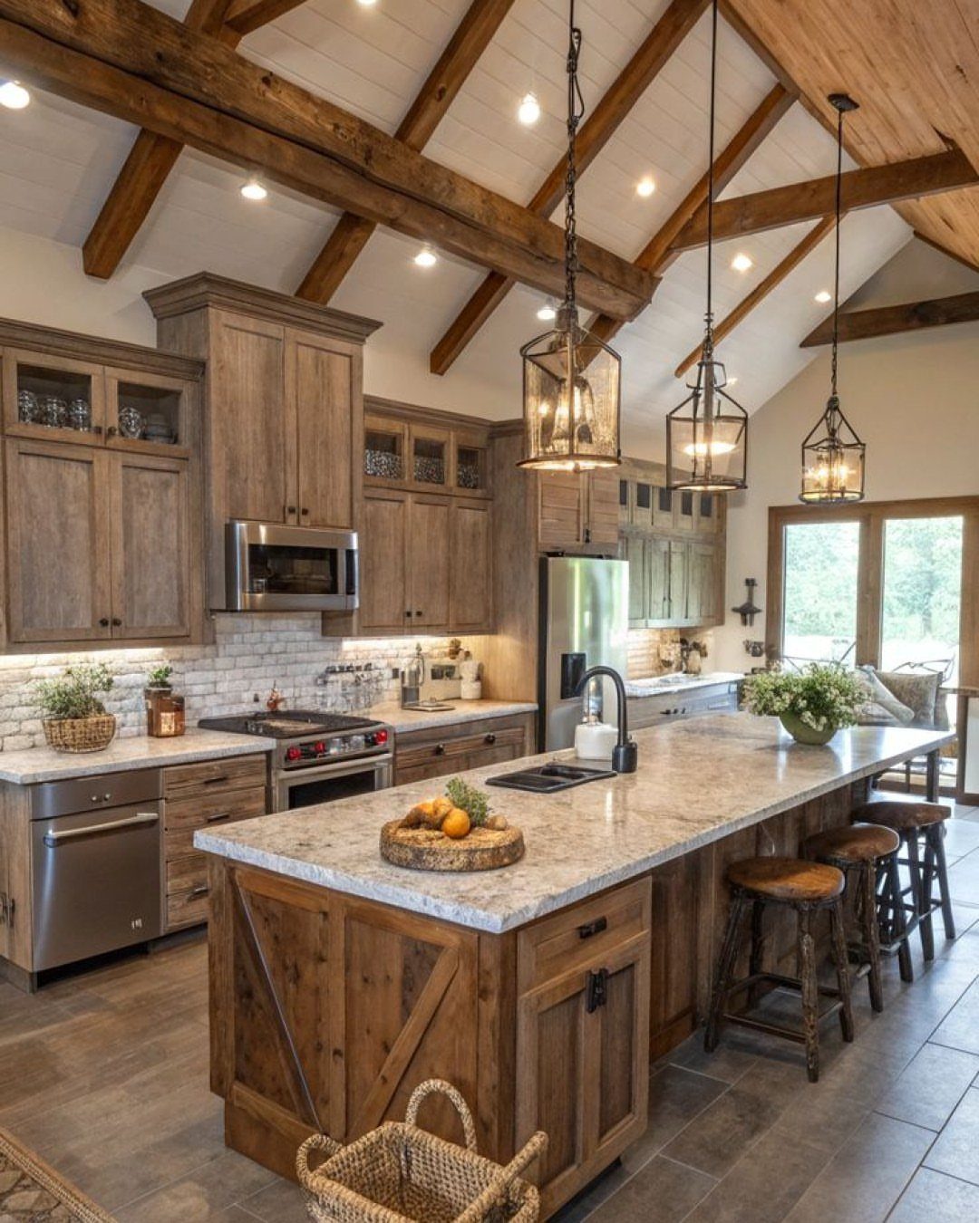 Large kitchen island with granite countertop and dark wooden ceiling beams overhead.