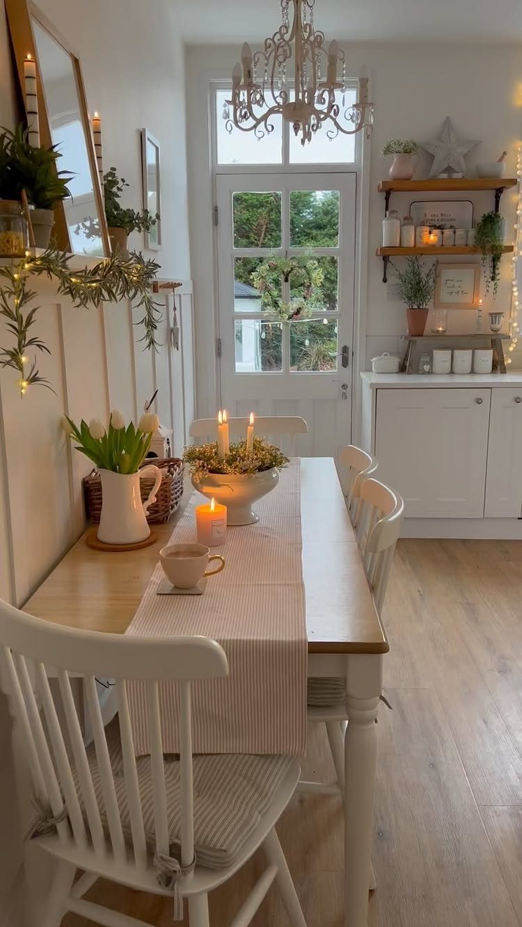 A bright dining room with white furniture, wooden table, and soft cream tones.