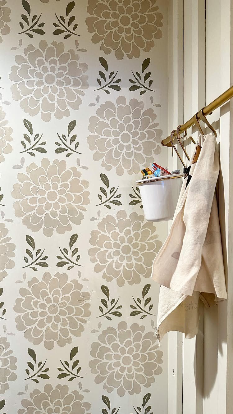 Floral patterned wallpaper in beige and olive green on a pantry wall.