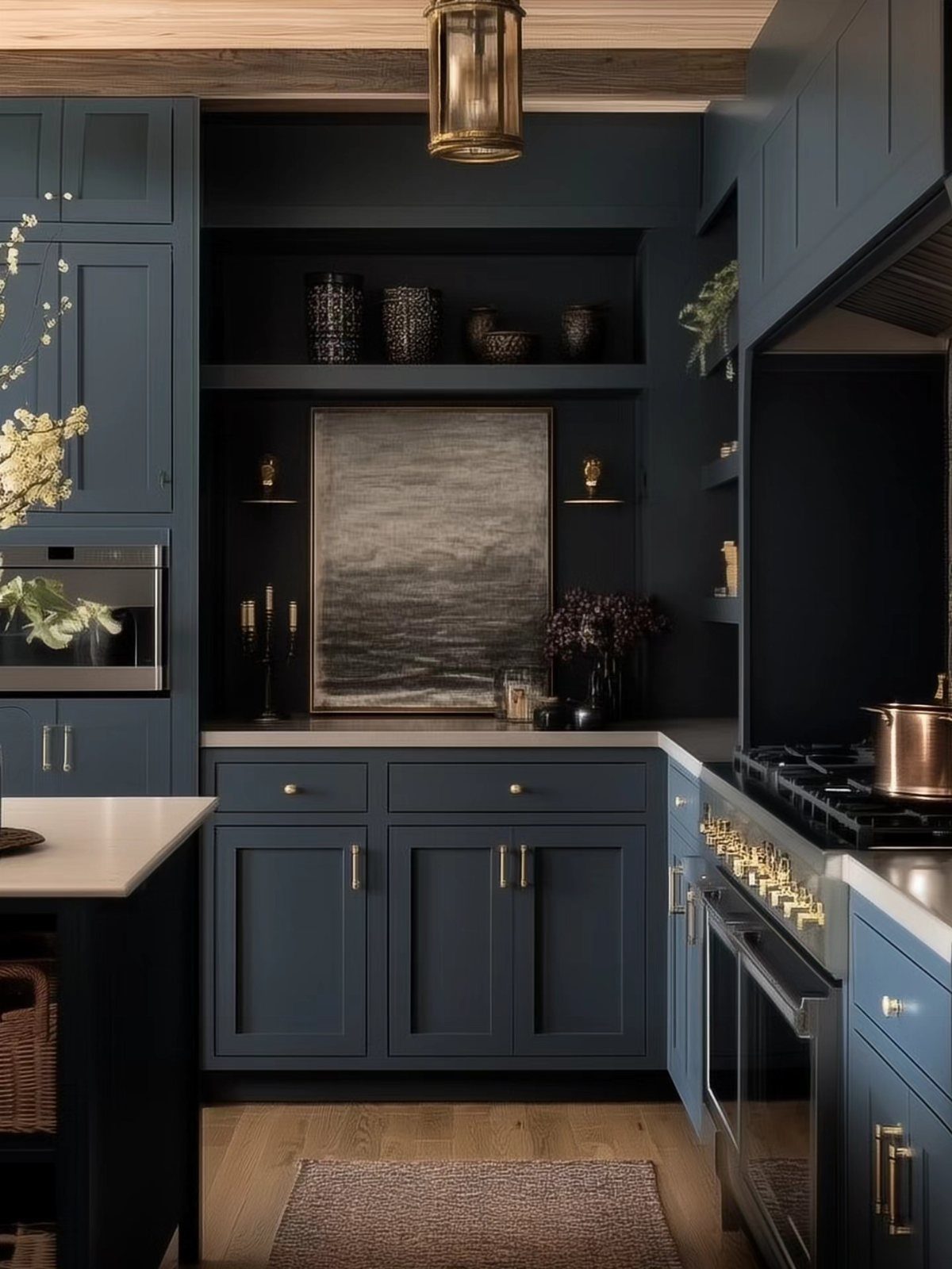 Navy blue kitchen cabinets with gold handles and light grey countertops in a modern kitchen.