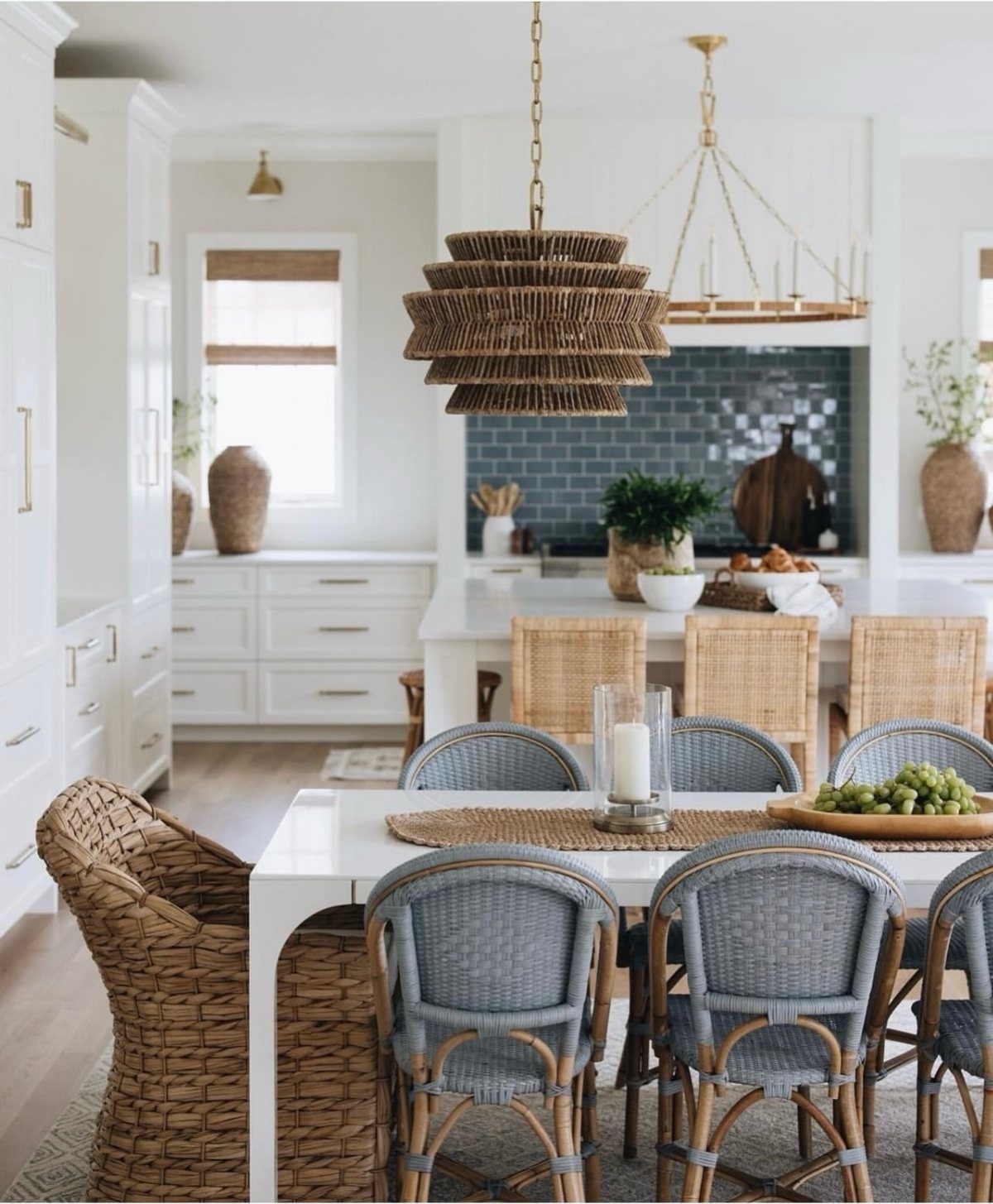 Woven pendant lights and blue backsplash in a bright, coastal style kitchen setting.