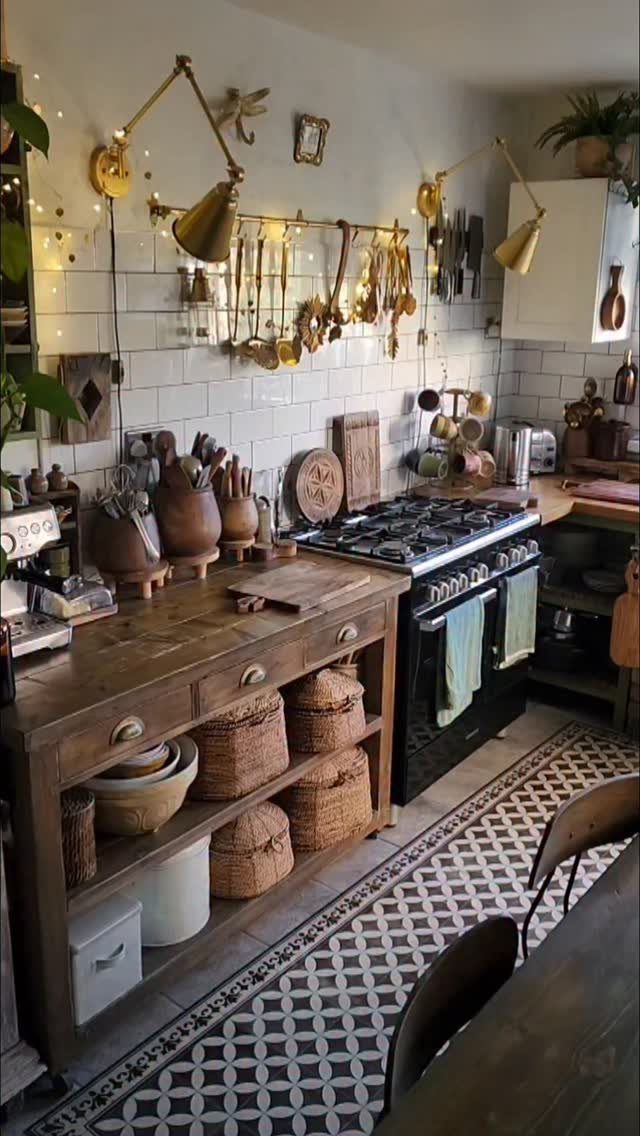 Wooden sideboard with woven baskets and kitchen utensils against a white subway tile backsplash.
