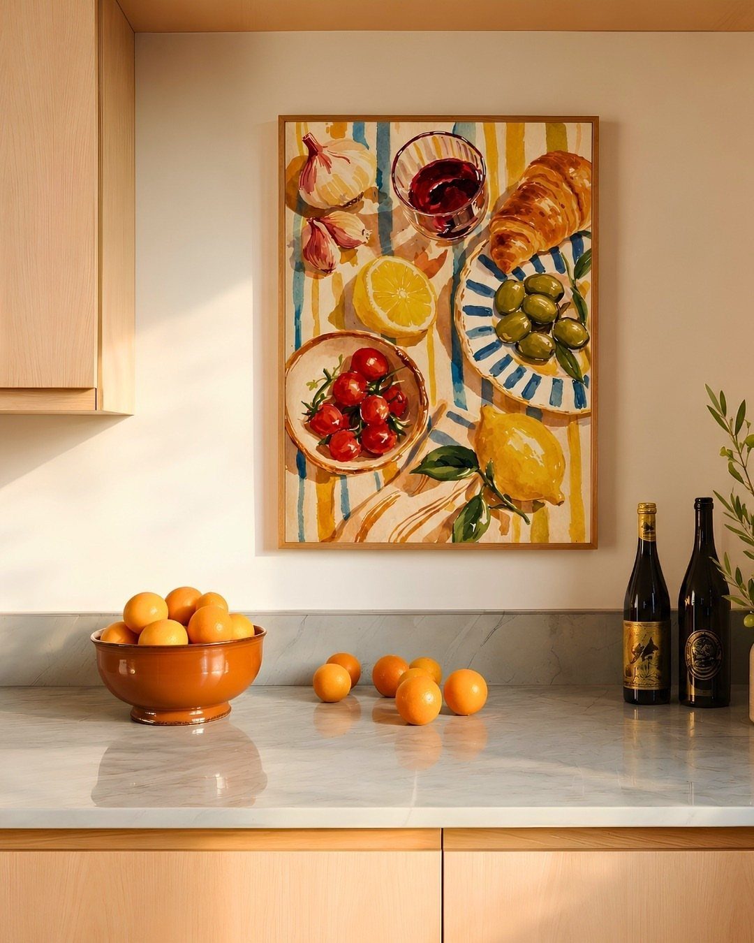 A colorful food painting hangs on a kitchen wall above a marble countertop with oranges.