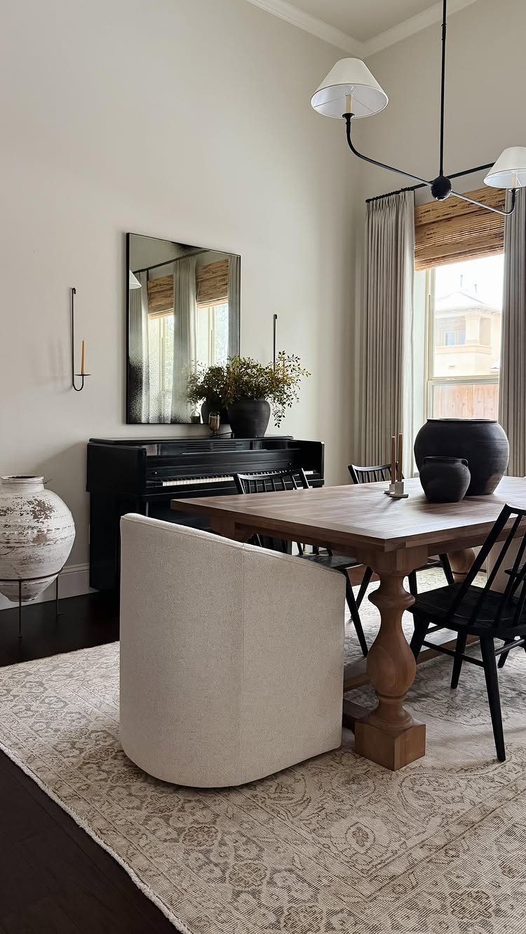 Cream upholstered dining chair positioned in front of a wooden table in a bright room.