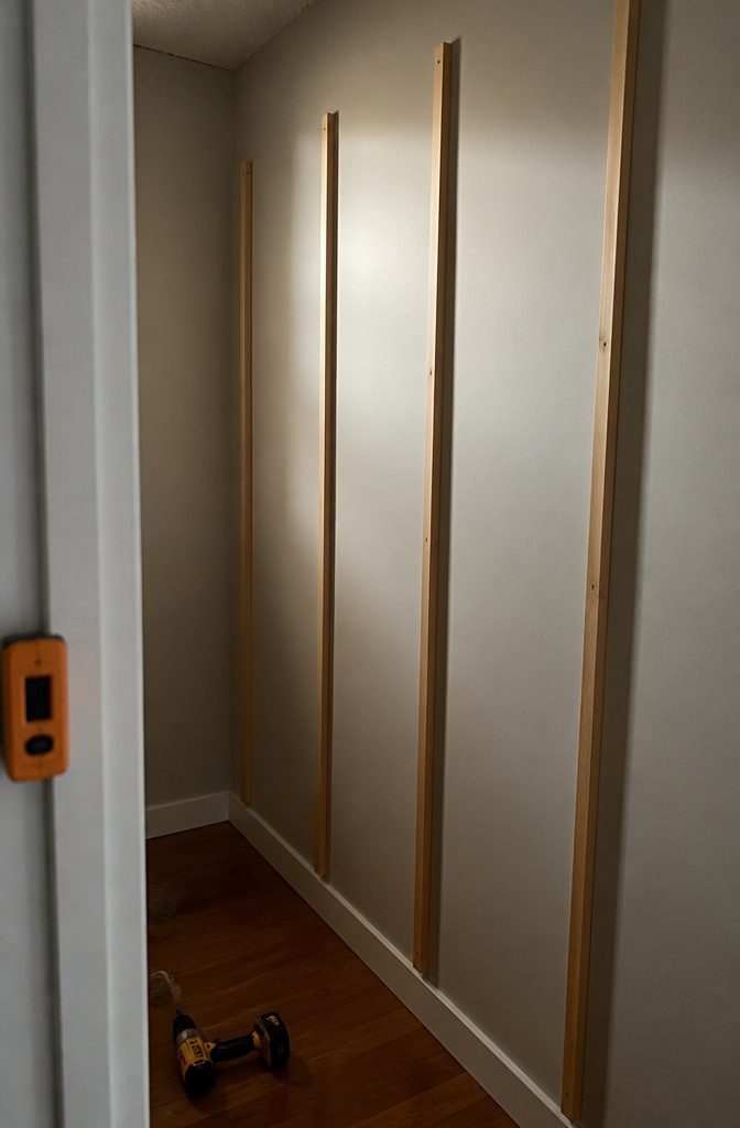 1x2 vertical supports fixed to a wall, ready for shelf installation.