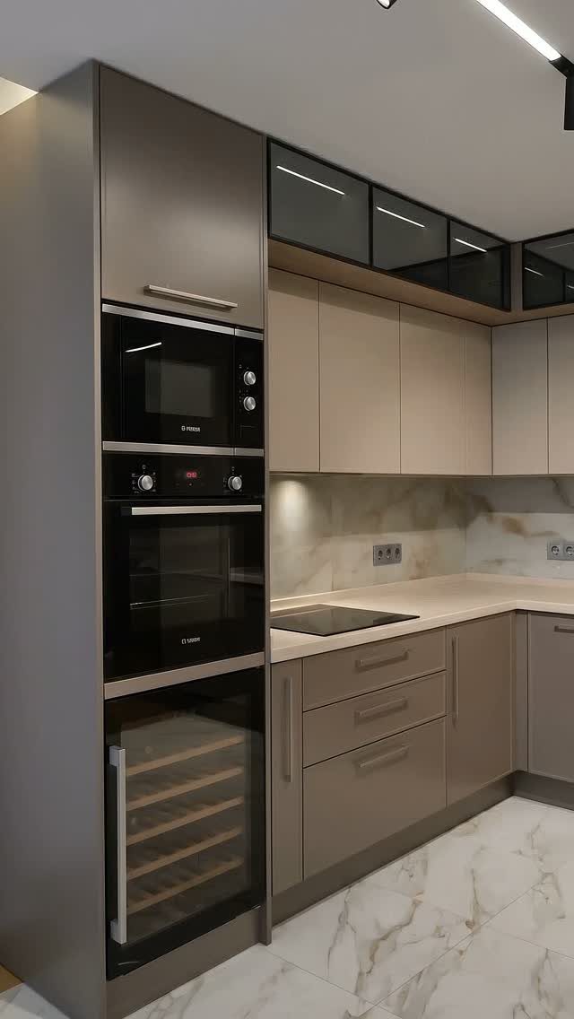 Built-in black microwave, oven, and wine cooler integrated into modern taupe kitchen cabinetry.