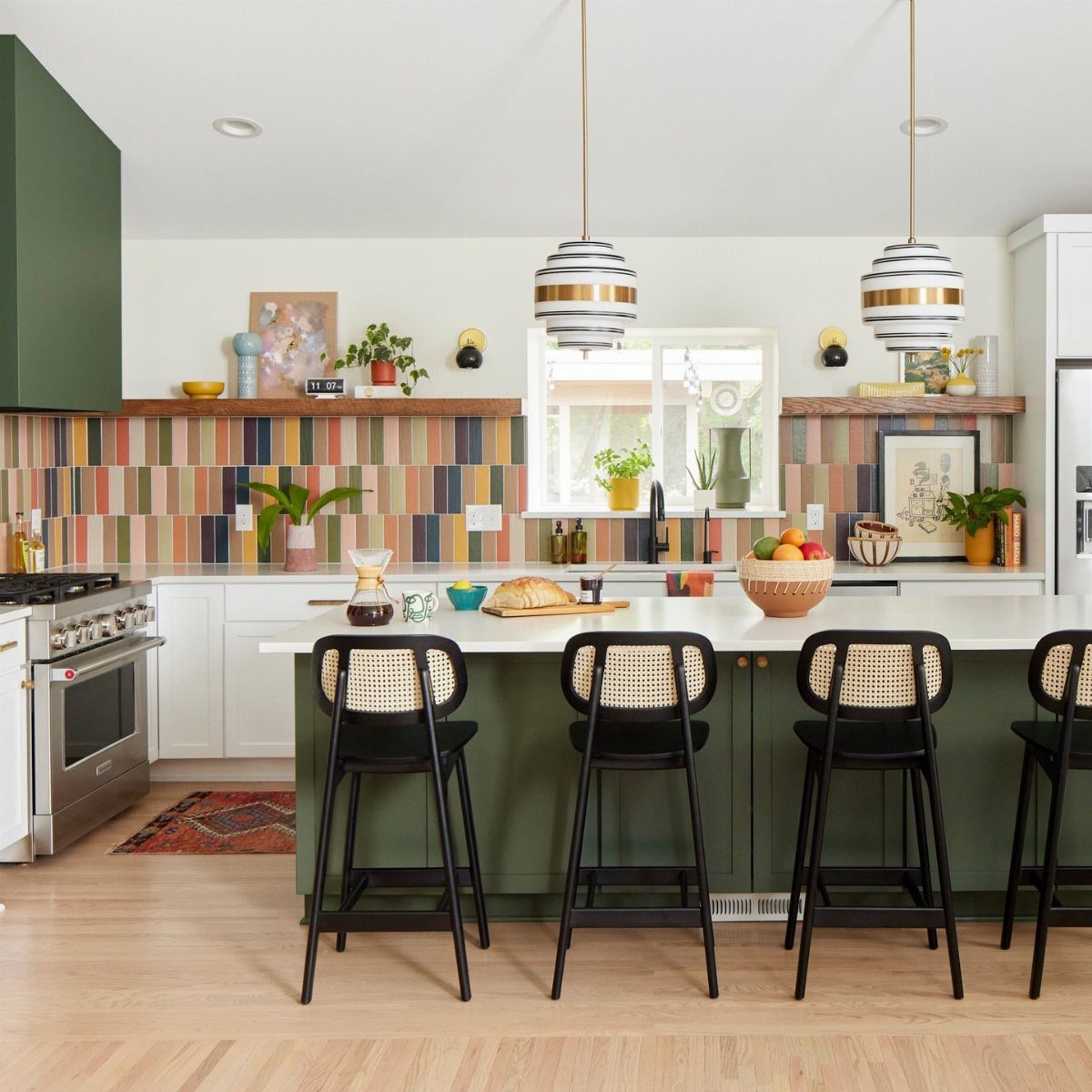 Colorful vertical rectangular tiles form a narrow decorative band across a modern kitchen backsplash.